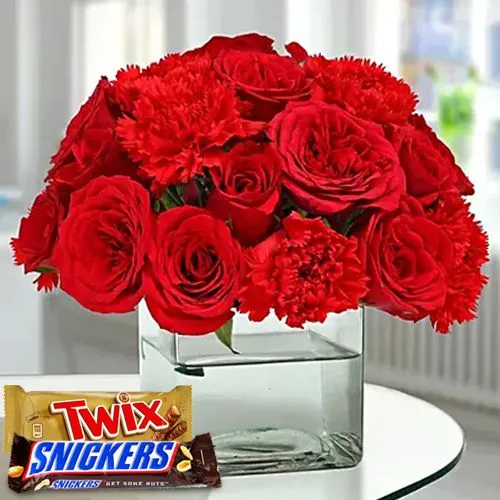 Breathtaking Journey of Red in Glass Vase with Snickers n Twix Chocolates