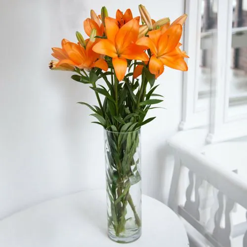 Exotic Lilies Arrangement in Glass Vase