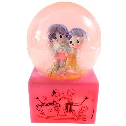 Romantic Love Couple with Floating Tinsel in a LED Lighted Glass Globe