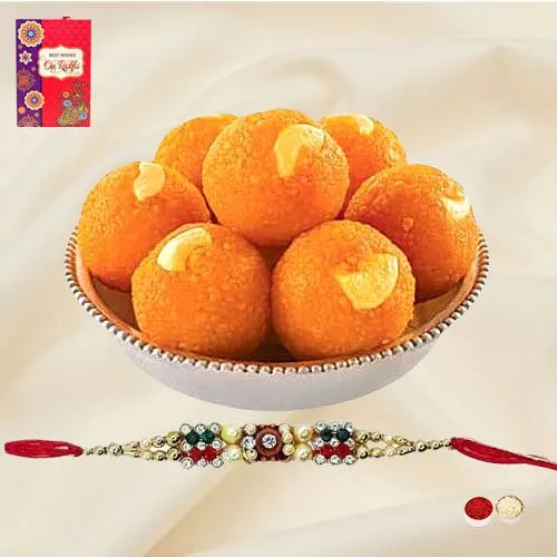 A Free Decorative Rakhi Roli Tilak and Chawal with Haldiram Pure Ghee Ladoo